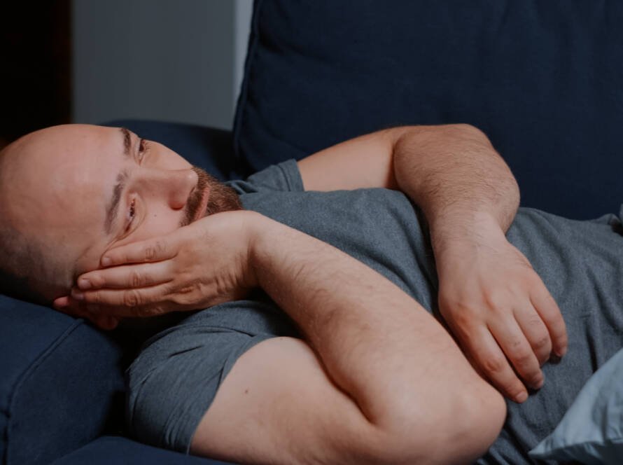 Patient sleeping with head elevated after hair transplant for proper recovery